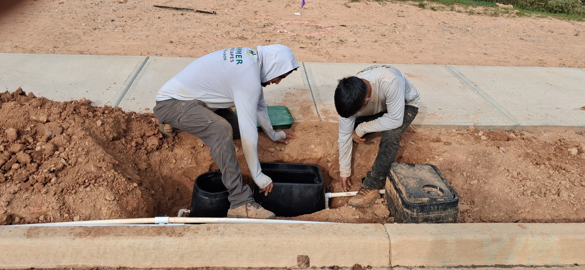 The Hammer crew installing irrigation piping and valve boxes.