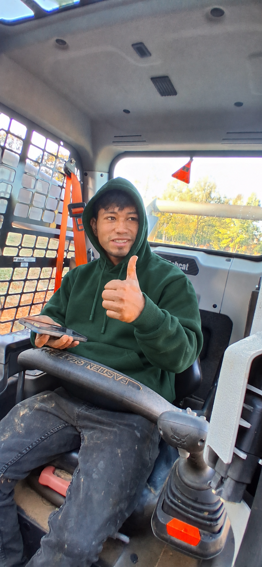 Marlow in his green Hammer hoodie at the skid steer